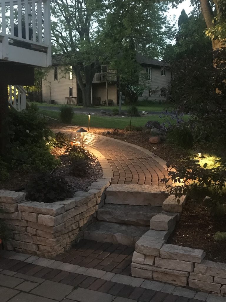 Evening view of a lit garden pathway and steps.